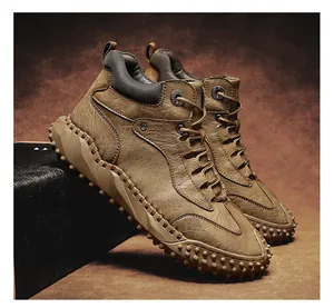 Detail view of men's high-top hiking boots with distressed leather and cleated soles.