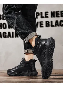 Professional close-up of black high-top outdoor boots with non-slip pebbled soles.