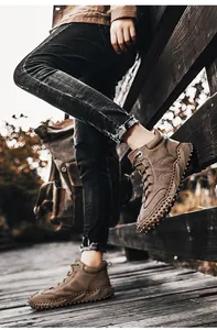Men's high-top outdoor leather boots shown in a rugged hiking scene on a boardwalk