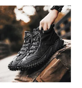 Detail view of durable black leather outdoor hiking boots with textured anti-slip sole