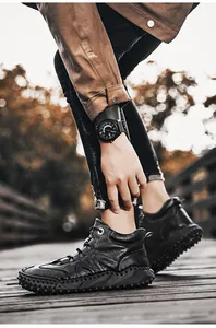 Detail of men's non-slip high-top boots with rugged sole shown in outdoor lifestyle setting