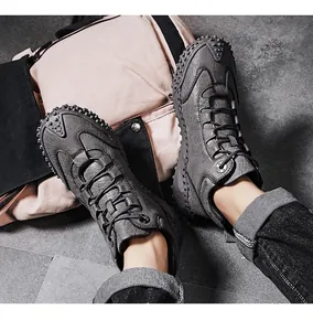 Top-down view of grey outdoor hiking boots paired with a canvas backpack background