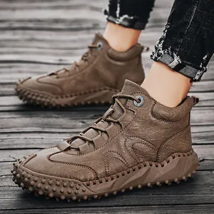 Men's high-top outdoor leather boots with hand-stitched details and studded soles