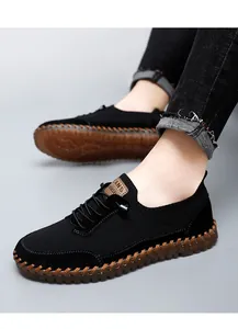 Close-up view of breathable black mesh casual shoes with durable brown gum soles for men