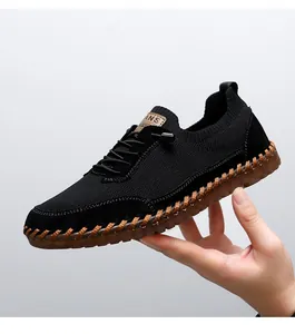 Detailed side view of breathable black mesh men's casual shoe with brown gum sole