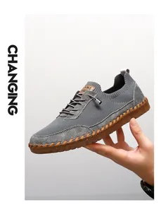 Detailed side view of grey breathable mesh men's sneakers with durable soft gum soles