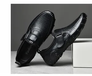 Detailed shot of black perforated leather loafers for men with slip-on design