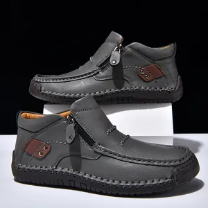 Scarpe alte in pelle grigia con dettagli cuciti a mano e cerniera