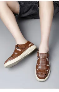 Detail of brown men's hollowed-out closed-toe sandals with adjustable buckle straps