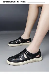 Close-up view of men's black breathable hollow-out casual sandals worn outdoors on feet