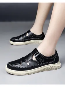 Detailed close-up showing the breathable hollow design of men's black summer sandals