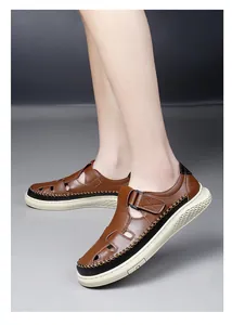 Side view of men's breathable brown hollow-out casual sandals on feet