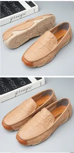 Detailed view of beige crocodile embossed leather loafers for men with soft rubber soles
