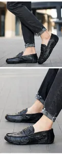 Close-up view of premium black crocodile-embossed leather loafers on male model's feet