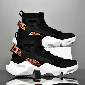 Detailed side view of high-top black sock sneakers with orange strap accents