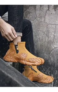 Detail view of tan high-top waterproof work shoes with a rugged anti-slip sole
