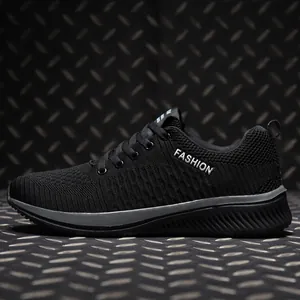 Side view of breathable black flyknit low-top athletic sneakers with lace-up design