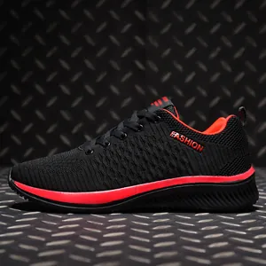 Detailed side view of breathable black flyknit sports shoes with vibrant red fashion accents