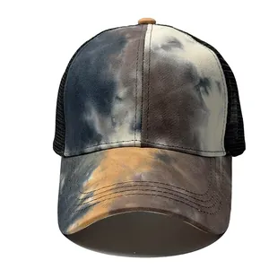 Close-up view of a stylish tie-dye camo print baseball cap with black mesh panels