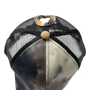 Detailed view of tie-dye mesh trucker hat featuring a functional ponytail hole design.