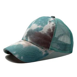 Close-up side view of a stylish tie-dye camouflage mesh back baseball cap in teal