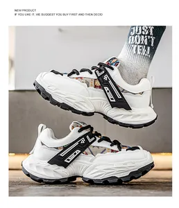 Λεπτομερής προβολή λευκών chunky dad sneakers με σόλα πλατφόρμα και μαύρες πινελιές