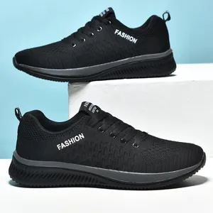 Macro side view of black breathable knit low-top running sneakers with fashion text