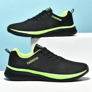 Side view of breathable black fly-knit sneakers with neon green accents and laces