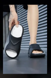 Detailed macro view of black and white men's sports slides showing EVA material texture