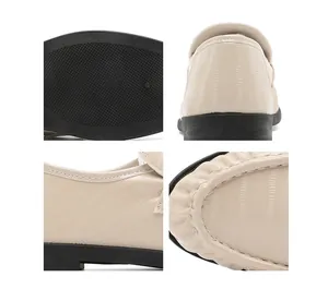 Detailed views of beige crocodile embossed loafers featuring a durable rubber sole