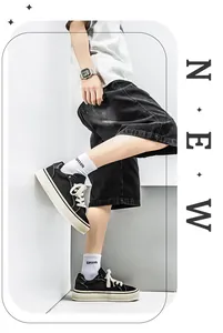 Close-up side view of fashionable black canvas sneakers worn by a model in a trendy setting