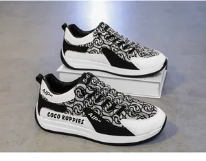 Detail view of men's black and white designer canvas sneakers with unique patterns