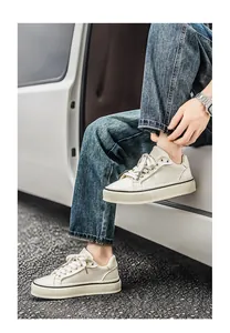 Stylish beige canvas sneakers for men shown in a casual outdoor lifestyle setting.
