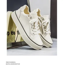 Macro view of cream platform canvas sneakers featuring premium textures and classic laces.
