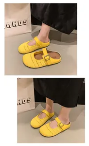 Detail view of stylish yellow mesh Mary Jane mules with thick sole and buckle strap