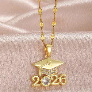 Close-up macro detail of golden graduation cap necklace pendant with 2026 and sparkling crystals