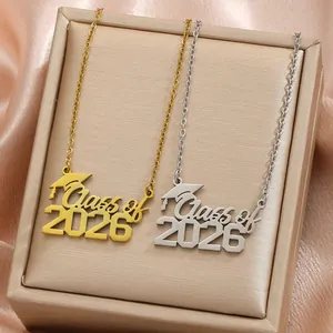 Close-up detail of gold and silver 'Class of 2026' graduation necklaces in a gift box.