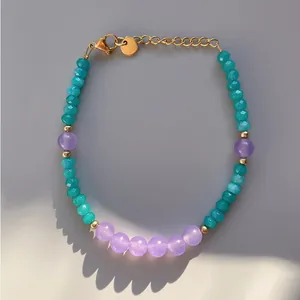 Detailed view of handmade beaded bracelet with teal faceted stones and purple beads