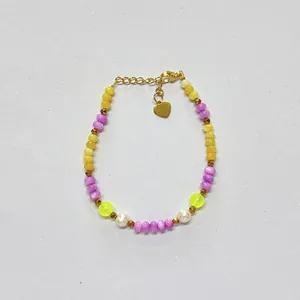 Close-up of colorful dopamine-style natural stone beaded bracelet with heart charm.
