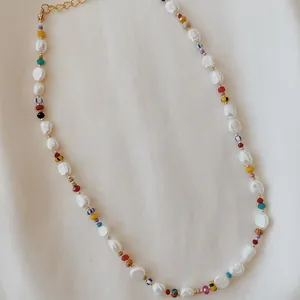 Close-up of handmade baroque freshwater pearl necklace with colorful mixed seed beads