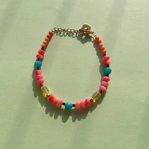 Detailed view of a colorful dopamine-style beaded bracelet with gold-toned clasp
