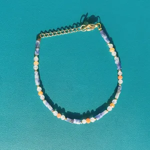 Close-up detail of faceted natural stone beaded bracelet with vibrant dopamine colors.
