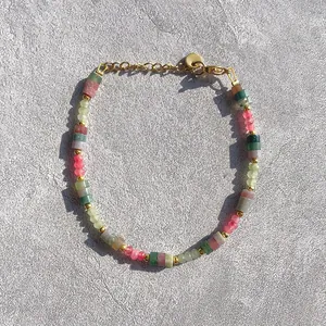 Detailed view of colorful natural stone beads and gold-plated hardware on a minimalist bracelet