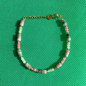 Close-up detail of colorful faceted natural stone beads on a gold-plated dopamine bracelet