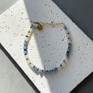 Faceted natural stone beaded bracelet with blue and opal beads and a gold heart charm