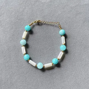 Detailed macro shot of a colorful candy-colored stone beaded bracelet with elegant gold spacers