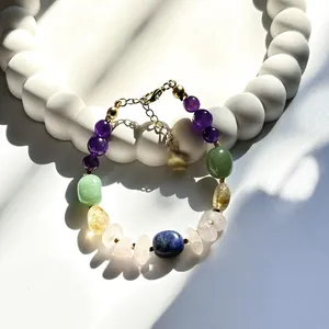 Close-up of vibrant multi-color natural stone beaded bracelet with adjustable gold clasp