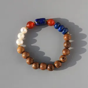 Close-up showing the varied textures of wood, pearl, and natural stone beads