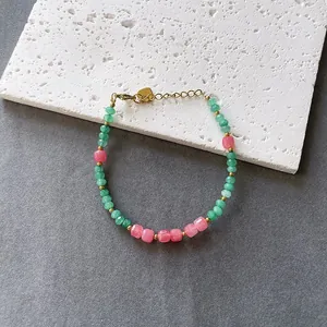 Colorful faceted natural stone beaded bracelet with gold accents in variant pink/green color.