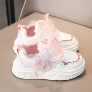 Scarpe sportive bianche da bambina con fiocchi rosa e dettaglio farfalla, vista laterale.